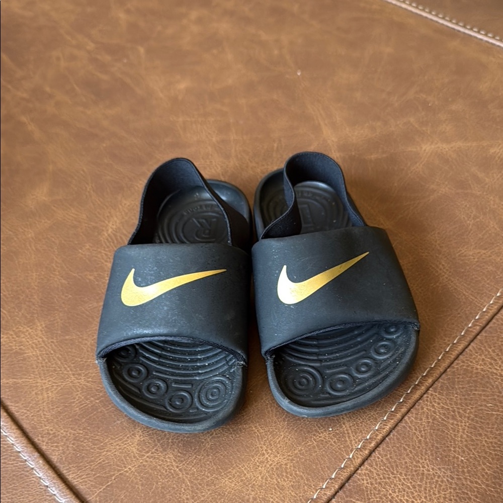 Nike Black and Gold Slide Sandals with Textured Footbed